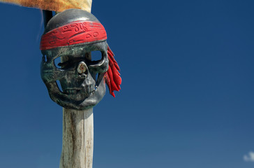 skull, totem pole with blue sky