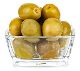 Whole green olives in a small transparent glass square bowl isolated on white background