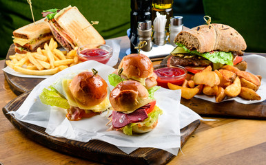 Wall Mural - three different mini burgers set on a wooden tray