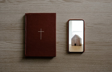 Worship from home, Online church for sunday service, Mobile screen with search icon, Bible on wooden table