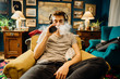 © eldarnurkovic - Young man gamer inhaling of a vapor with electronic cigarette.Vape flavor liquid chemicals.Use of e-cigarettes in the home.Smoking and vaping negative health effects.Smoking habit,nicotine addiction.