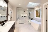 Fototapeta  - Luxury modern home bathroom interior with dark brown cabinets, white marble, walk in shower, free standing tub.