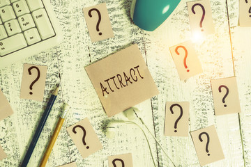 Poster - Handwriting text writing Attract. Conceptual photo to draw by a physical force causing or tending to cause to approach Writing tools, computer stuff and scribbled paper on top of wooden table