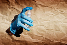 Hand In A Medical Glove Closeup. An Old Hand With A Disinfector In The Hand Of A Coronavirus Infection Vaccine. Antiseptic As A Safety Measure For An Outbreak Of Coronavirus In The World. Quarantine A