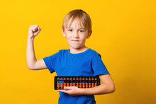 Schoolboy With Abacus Over Yellow Background. Kid Study At Mental Arithmetic School.