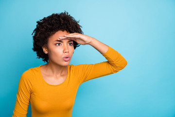 Poster - Portrait of astonished afro american girl hold hand forehead watch far away cant see people friends family wear modern fall autumn outfit isolated over blue color background