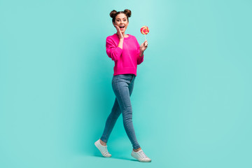 Poster - Full length body size view of nice attractive lovely amazed cheerful cheery wavy-haired girl walking eating lolli-pop isolated on bright vivid shine vibrant green blue color background