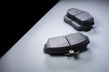 Single Wheel Kit New Brake Pads On A Gray Gradient Background. The Concept Of New Spare Parts For Car Suspension