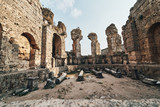 Fototapeta  - Ancient city of Perge near Antalya Turkey. Ancient Ruins of Rock and Stone in the evening sun.