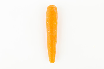 Human hand holding a fresh carrot. Fre copy space.