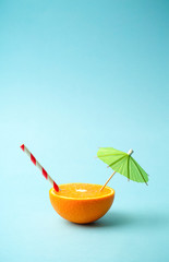 Food summer minimal concept. Orange juice and juicy tropical fruits on a light colored background