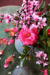 pink flowers in old watering can