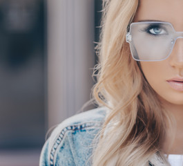 Wall Mural - Portrait of pretty stylish blonde woman in blue sunglasses in outdoor.