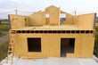 © bilanol - Construction of new and modern modular house. Walls made from composite wooden sip panels with styrofoam insulation inside. Building new frame of energy efficient home concept.