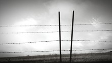 Barbed Wire Fence Against Sky On Field