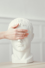 The female hand closed her eyes to the sculpted head. The concept of not seeing and not noticing. Caesar's head