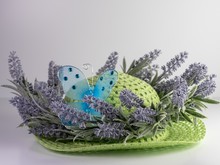 Closeup Picture Of A Green Straw Hat Decorated With Purple Lavender And Blue Butterfly