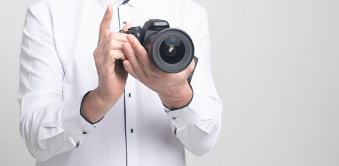 Aufkleber - camera in hands of a man in white clothes with copy space