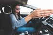 © blanke1973 - an angry young girl drives a car and points with her hands