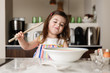 © Lisa Tichané - Cute toddler girl preparing food in kitchen