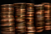 Stacks Of Pennies On A Black Background.