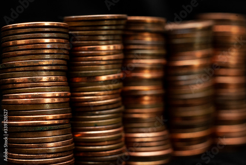 Cuadros en Lienzo Stacks of pennies on a black background.