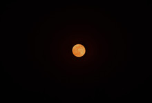 A Red Full Moon In The Dark Sky At Night