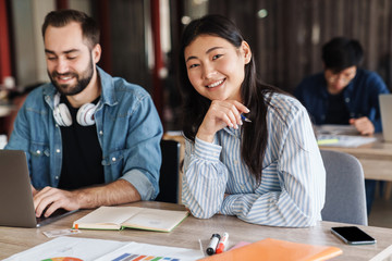 Sticker - Photo of multinational cheerful students smiling while studying