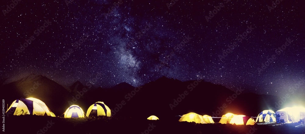 Panoramic Shot Of Illuminated Tents Against Star Field - obrazy, fototapety, plakaty 