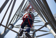 © kitawit - Worker with safety equipment climb high telecom tower for 5G maintenance working,High risk working.