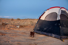 Wild Camping Tent With Hiking Boots And Logs In The Backcountry Desert Of The Bisti Badlands, De-Na-Zin Wilderness, New Mexico
