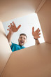 © Pixel-Shot - Happy man with open box, view from inside
