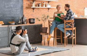 Wall Mural - Photographer working with young couple in studio