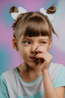 Girl with finger in her nose on colorful background