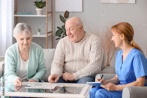 Fotografía Elderly people suffering from mental disability and caregiver in nursing home