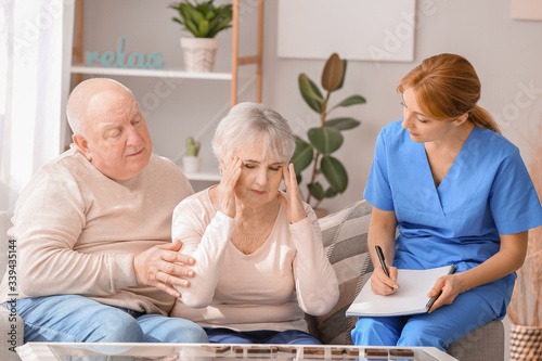 Cuadros en Lienzo Elderly people suffering from mental disability and caregiver in nursing home