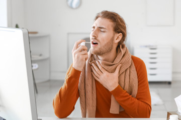 Poster - ill young man with inhaler at workplace