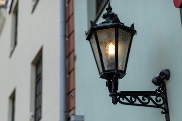 Wall Mural - Old fashioned street lamps at night on background old building