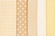 © Nikolay - Mix of beige, white and brown cotton fabric.
