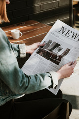 Woman reading paper news