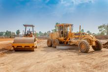 Motor Grader And Vibratory Roller Compactor Working In Site Construction. Road Construction Heavy Equipment