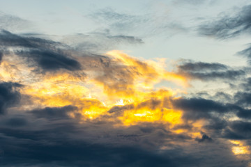 Wall Mural - Dramatic and moody yellow, purple and blue cloudy sunset sky. Abstract nature background