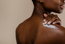 African Woman Applying Lotion