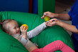 © Yekatseryna - sensory therapist massaging little girl patient with a little ribbed ball