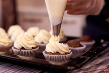 Chocolate Cupcakes With A Swirl Of Cream Close-up. Selective Focus.