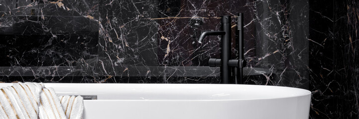 Wall Mural - Black faucet in elegant white bathtub, panorama