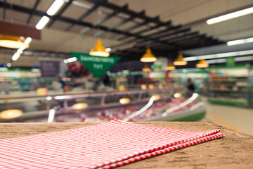 Supermarket background, Counter over blur grocery background, Wooden desk, table, shelf and blur woman shopping at supermarket, Wood counter for grocery store retail product display backdrop, template