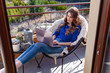 © Gabi Moisa - Beautiful young woman working from home on the balcony