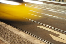 Blurred Motion Of Yellow Cable Car In City