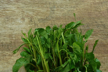 Wall Mural - morning glory or water spinach tropical vegetable on wooden table